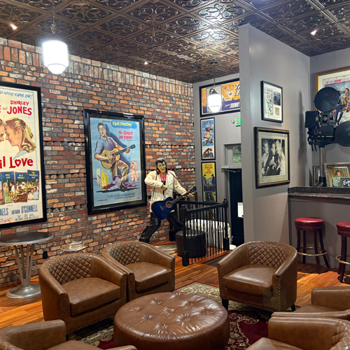 Wing Knights speakeasy event room with leather seating and Elvis statue